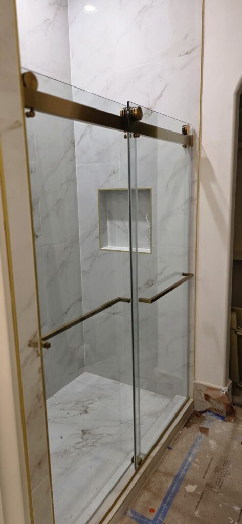 Shower with brushed-gold glass door – Fixora Remodeling, Plano TX