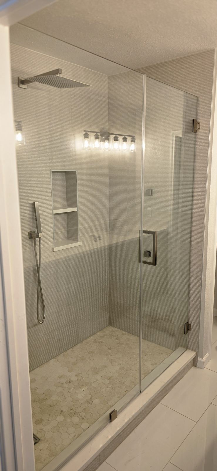 A built-in shower niche keeps bottles off the floor and gives a clean, custom look.