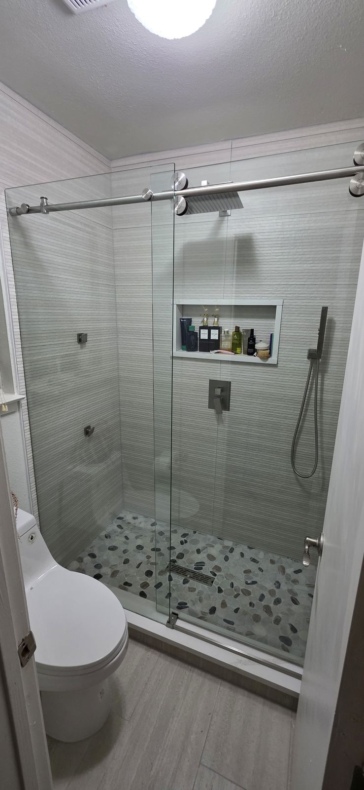 A frameless shower enclosure shows off the tile and is easy to keep clean.