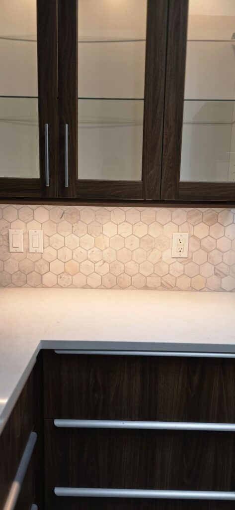 Glass-front cabinets & hex backsplash – Fixora Remodeling, Plano TX