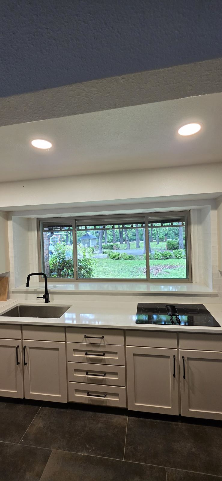 Good natural light, a deep sink and simple finishes make a kitchen easy to use every day.
